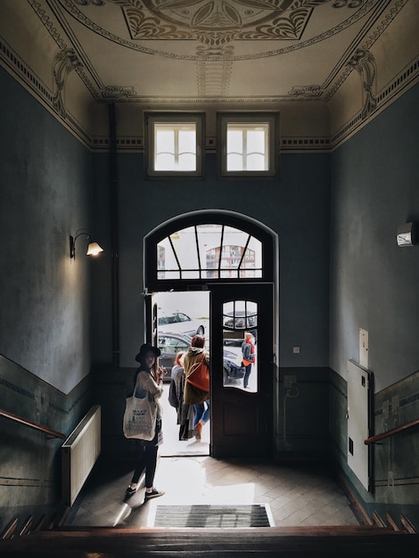 Woman standing at entrance of building