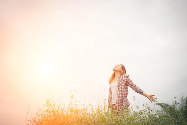 woman standing on field against sky during sunset