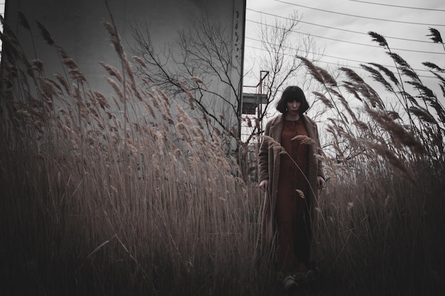 woman standing on field against sky