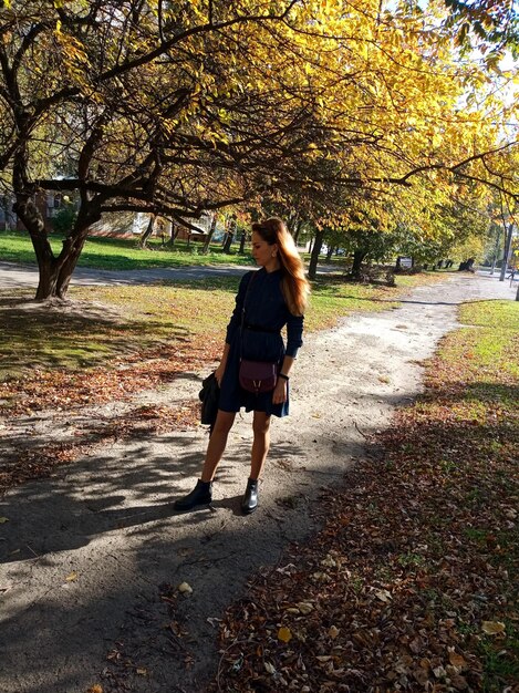 Woman standing on footpath