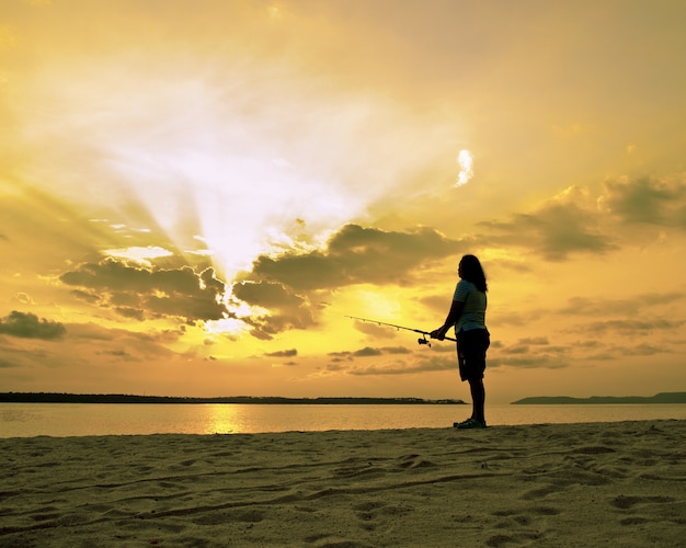 woman standing in front of beautuful sunset