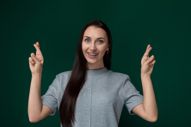 Woman standing in front of green wall