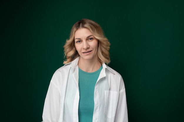 Woman standing in front of green wall