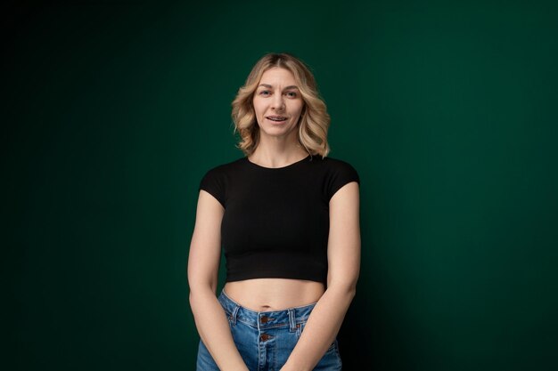 Woman standing in front of green wall