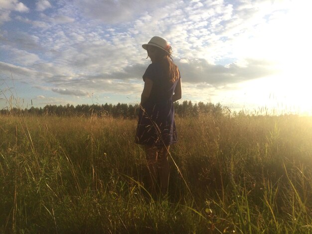 Woman standing on grassy field