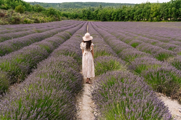 Woman standing in the middle of a lavender field