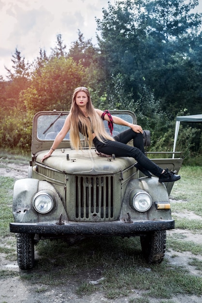 Woman standing in military car posing outdoors