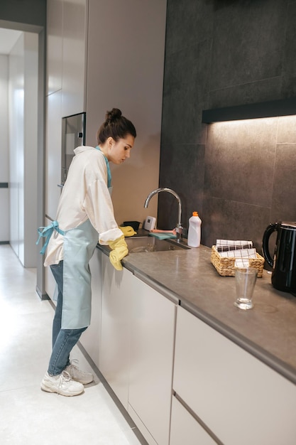 Woman standing near the countertop and looking tired