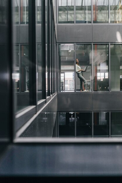 Woman standing at office window