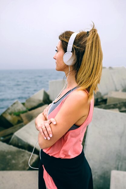 Woman standing on pier against sky