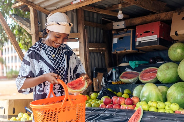 Woman Standing Next to Pile of Watermelon