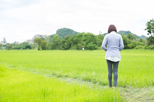 Woman standing in the rice fields.