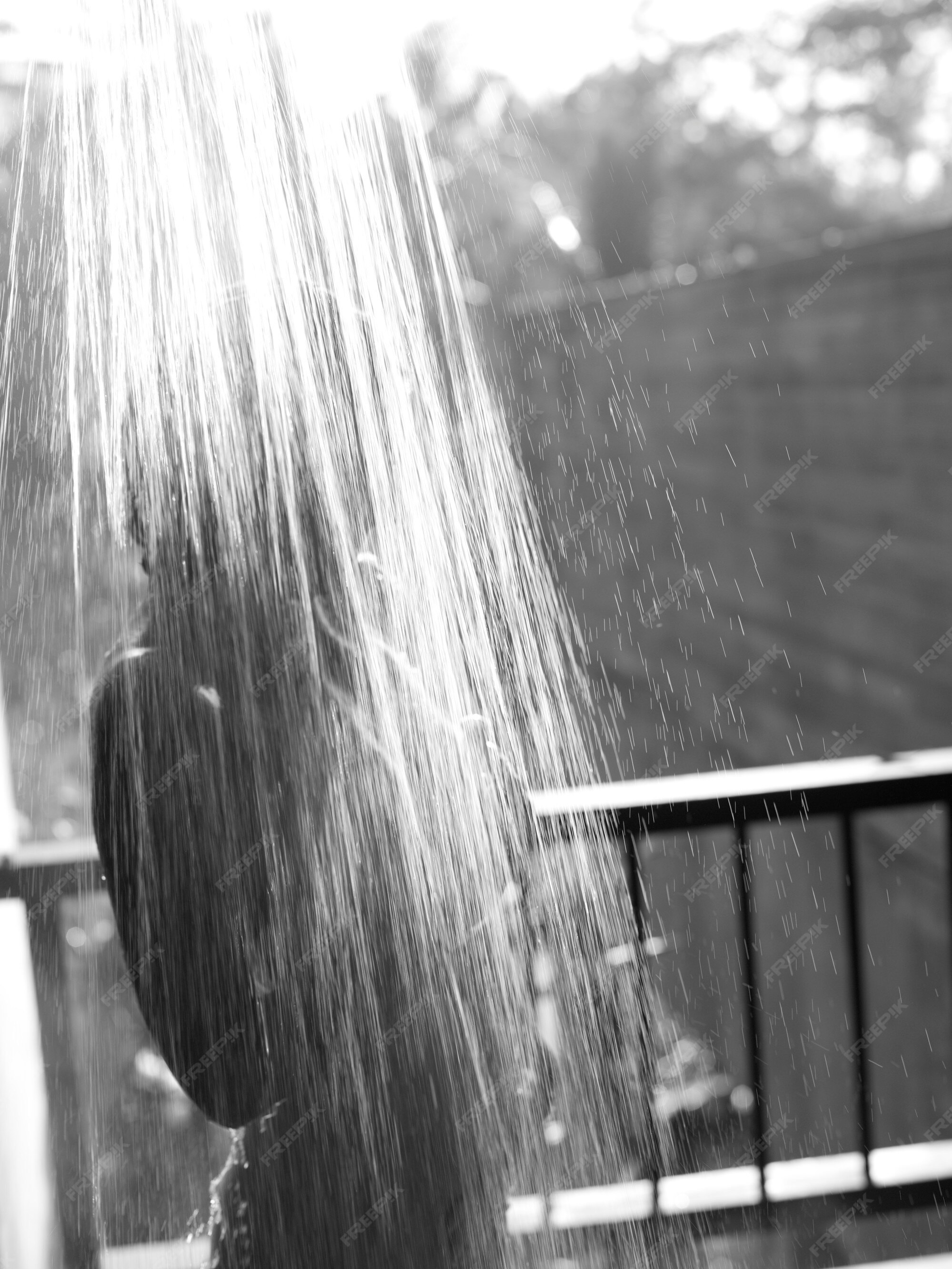 Premium Photo Woman standing under shower of water in bali
