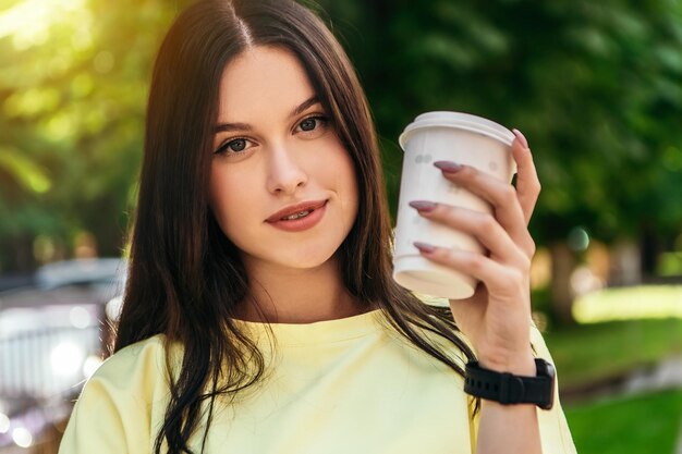 Woman standing street and drink coffee