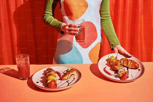 Photo a woman standing next to a table with two plates of food