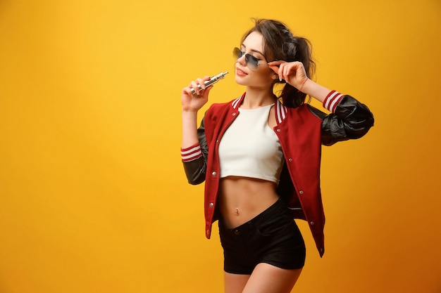 Woman standing and vaping in studio