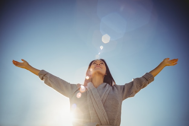 Woman standing with arms outstretched