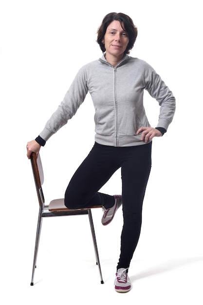 Woman standing with a chair in white background