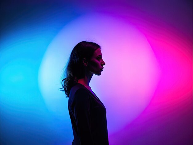 a woman stands in front of a colorful light