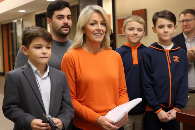 Photo a woman stands with two boys and a man in a suit and the word  the  the  on the front