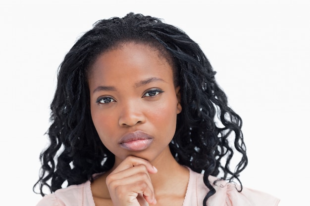 A woman staring at the camera resting her head on her hand