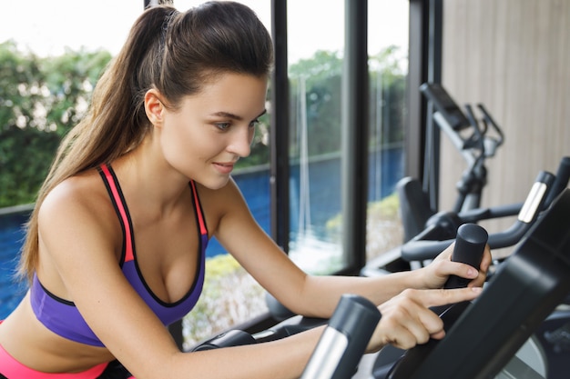 Woman on stationary bike in the gym