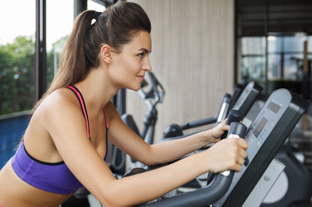 Woman on stationary bike in the gym