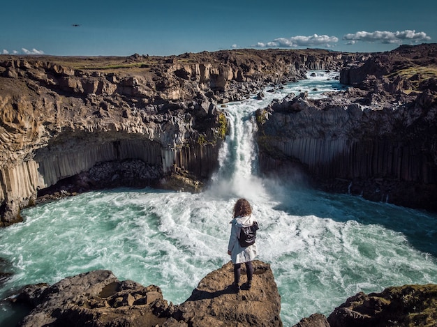 Woman stay on waterfall in iceland hide waterfall in iceland a