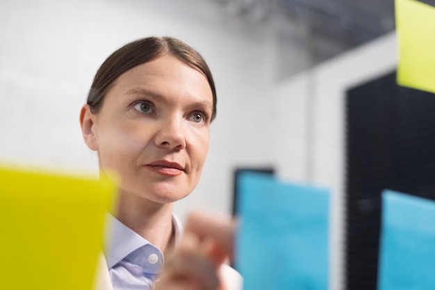 Woman sticking post its on window