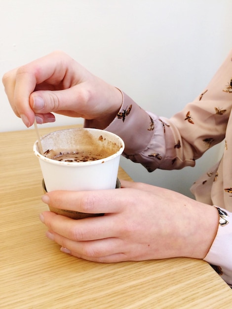 Woman stirring coffee