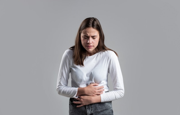 Woman Stomach Ache. Woman touching his stomach. Stomach pain and others stomach disease concept.Girl having a stomachache. Young woman suffering from abdominal pain.