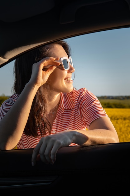 Woman stop to enjoy sunset at road trip car travel