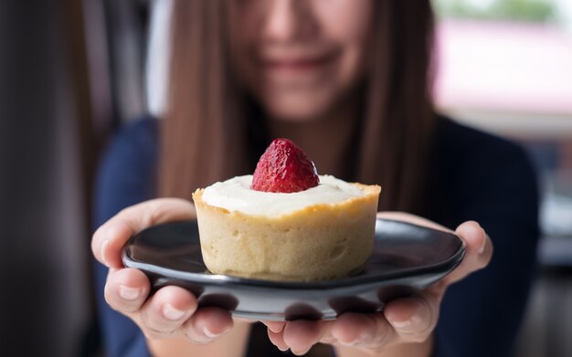 woman and strawberry cheese tart