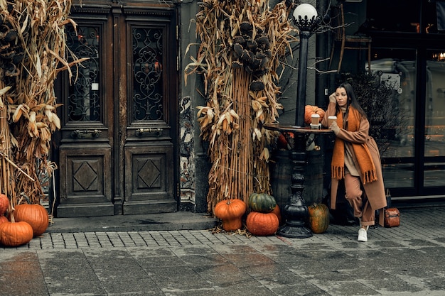 woman on the street with a disposable paper cup. Take away food, walk around the city.