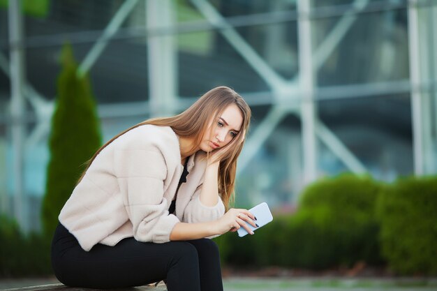 Woman stressed from work while sitting outdoors