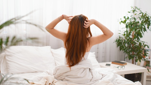 Woman stretching after waking up Entering a day happy after good night sleep.