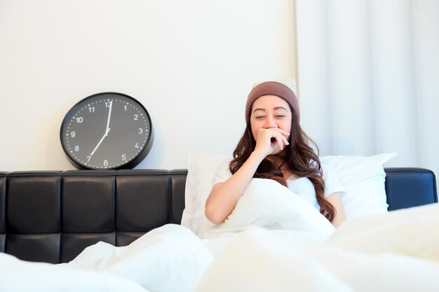 Woman stretching in bed after wake up, concept for healthy.