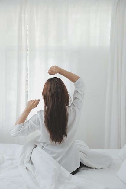 Woman stretching in bed after wake up