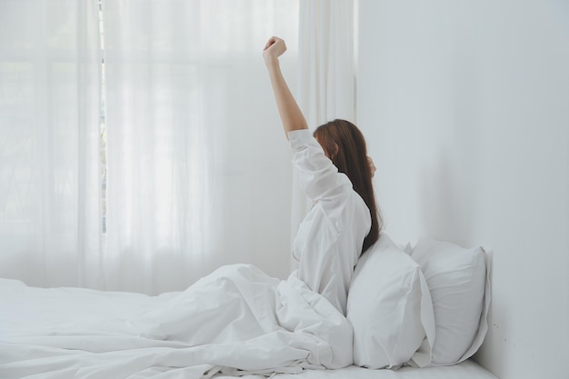 Woman stretching in bed after wake up