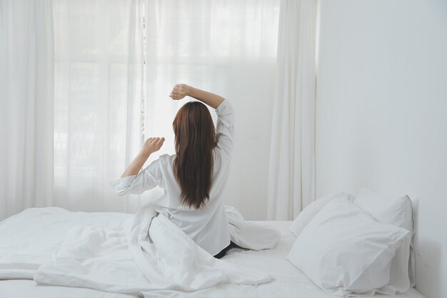 Woman stretching in bed after wake up