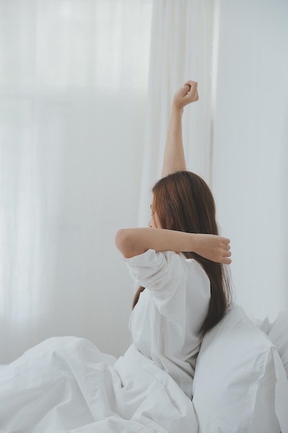 Woman stretching in bed after wake up