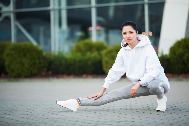 Woman Stretching Body Doing Exercises On Street