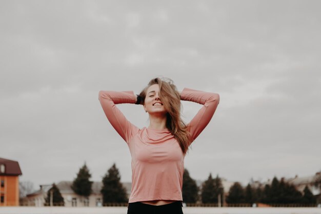 Woman stretching and doing exercises at the stadium