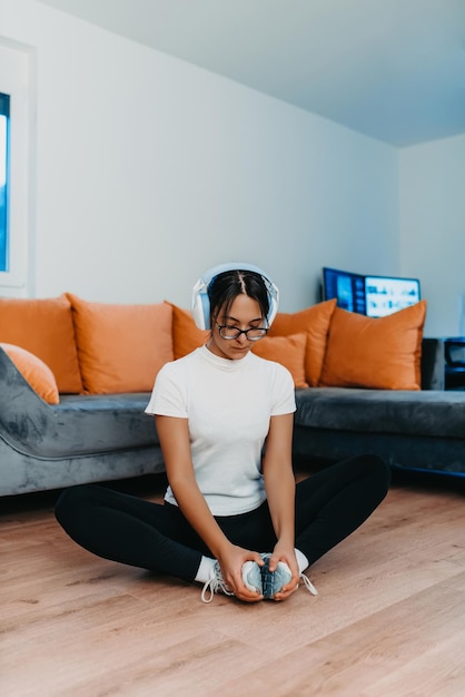 A woman stretching in her apartment during early morning after training reflecting her dedication to