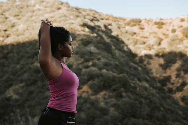 Woman stretching while on a hike