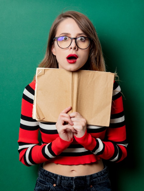 Photo woman in striped sweater and glasses with book