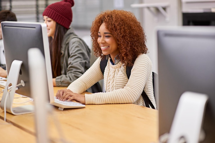 Photo woman student and computer for affirmative action online course and study with scholarship resources at college female person learning and virtual class in library for tech and internet access