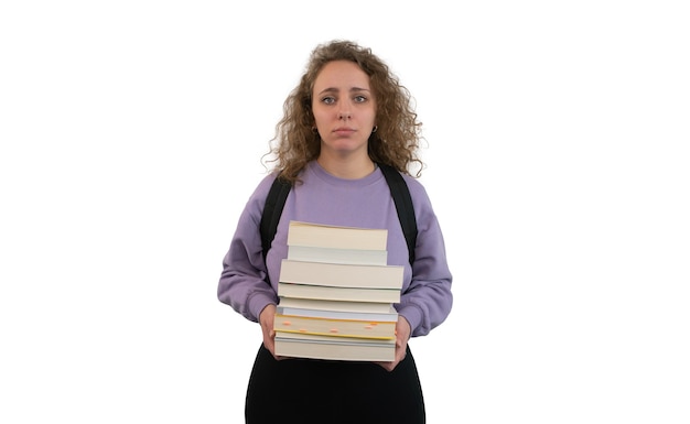 Woman student shows frustration face while holding many books and notebooks isolated