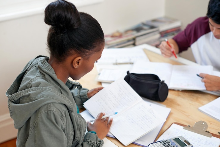 Photo woman students and reading book in university for learning knowledge or math test preparation college team and people study textbook for information education and help for exam in class top view
