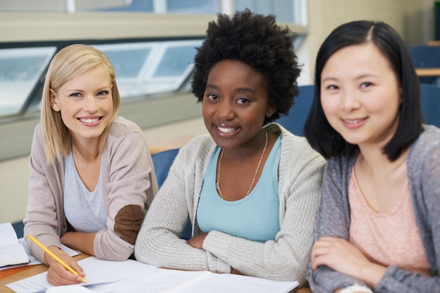 Photo woman students and studying in university lecture hall with notes prepare and plan for exam ideas smile and focus on plan for determination knowledge and information for assessment task